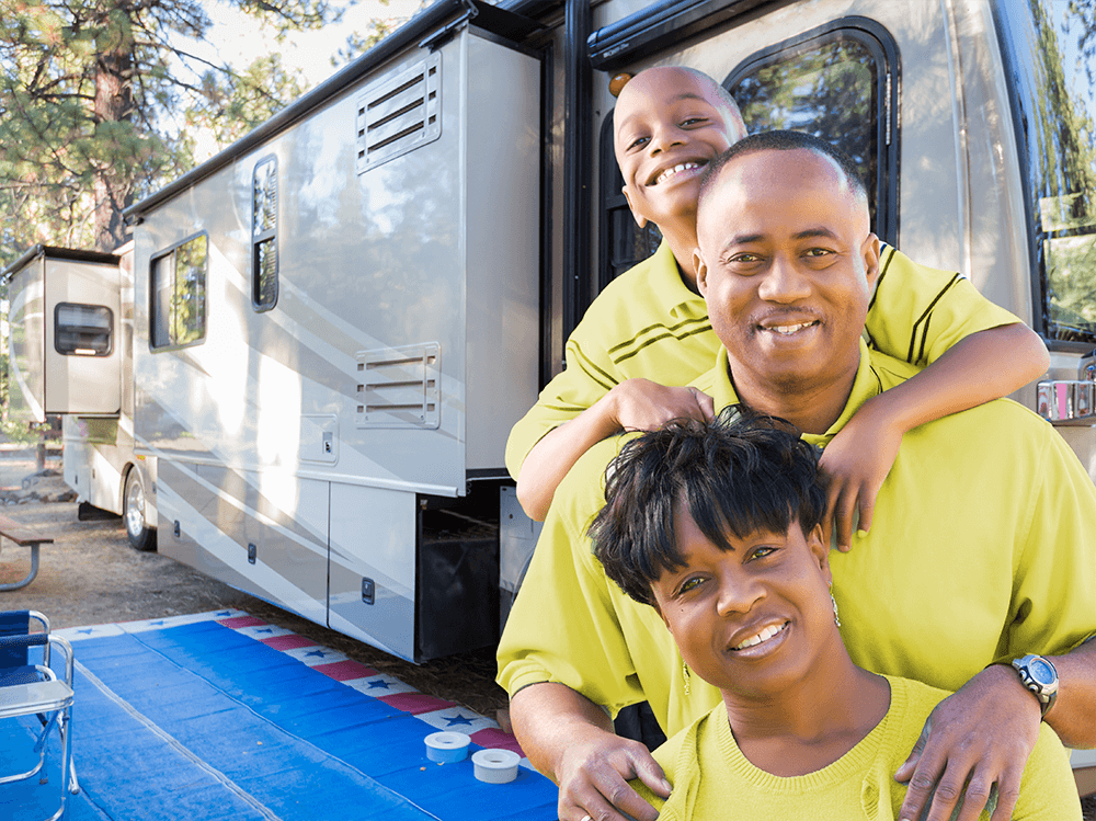 African American family in matching yellow shirts posing infront of their RV campsite | Metro East, IL