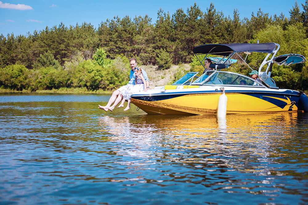 Yellow liesure boat with family enjoying a day at the lake | Metro East, IL